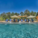 countryside swimming pool with wooden deck and water features