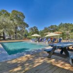 shaded sitting area next to swimming pool in texas countryside