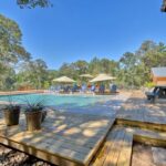 wooden pool deck and shaded patio area