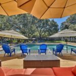 umbrellas and lounge chairs by swimming pool in texas countryside