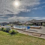 expansive backyard swimming pool and patio in countryside