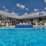 blue water swimming pool back patio