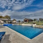 rectangular swimming pool and outdoor lounge area in Brenham texas